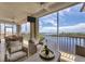 Bright living room with water views and access to a screened balcony at 13213 Gasparilla Rd # B601, Placida, FL 33946