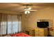 Bedroom featuring a ceiling fan, dresser, and window coverings at 13537 Bennett Dr, Port Charlotte, FL 33981