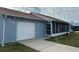 Cute light blue home with a screened porch and one car garage at 13537 Bennett Dr, Port Charlotte, FL 33981