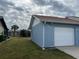Side view of the house showing the garage and backyard at 13537 Bennett Dr, Port Charlotte, FL 33981