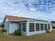 View of back of house showcasing large sunroom addition at 13537 Bennett Dr, Port Charlotte, FL 33981