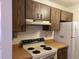 Kitchen with older appliances and wood cabinets at 13537 Bennett Dr, Port Charlotte, FL 33981
