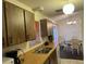 Kitchen with view into dining area, featuring wood cabinets at 13537 Bennett Dr, Port Charlotte, FL 33981