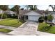 Single story house with a white garage door and green lawn at 1441 Strada D Oro, Venice, FL 34292