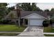 Single story home exterior with a landscaped yard and attached garage at 1441 Strada D Oro, Venice, FL 34292
