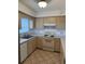 Galley style kitchen with beige cabinets and tiled floor at 1441 Strada D Oro, Venice, FL 34292