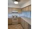 Beige cabinets and countertops, white appliances in this kitchen at 1441 Strada D Oro, Venice, FL 34292