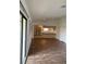Living room with wood-look floors and kitchen view at 1441 Strada D Oro, Venice, FL 34292
