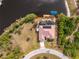 Aerial view of single-story home with pool and canal access at 14448 Edna Cir, Port Charlotte, FL 33981