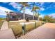 Landscaped backyard with pool and canal views at 14448 Edna Cir, Port Charlotte, FL 33981