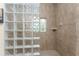 Shower with glass block wall and tiled floor at 14448 Edna Cir, Port Charlotte, FL 33981