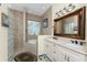 Bathroom with double vanity, large mirror, and glass block shower at 14448 Edna Cir, Port Charlotte, FL 33981
