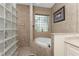 Spa-like bathroom with soaking tub, glass block window, and tiled shower at 14448 Edna Cir, Port Charlotte, FL 33981