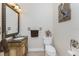 Small bathroom with vanity, toilet and decorative wall art at 14448 Edna Cir, Port Charlotte, FL 33981