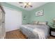 Light green bedroom with king-size bed, double doors, and wood floors at 14448 Edna Cir, Port Charlotte, FL 33981