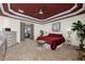 Spacious Primary bedroom with red bedding and a view into another room at 14448 Edna Cir, Port Charlotte, FL 33981