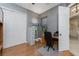 Home office with wood floors, desk, and built-in shelving at 14448 Edna Cir, Port Charlotte, FL 33981