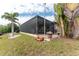 Screened-in patio with lush landscaping at 14448 Edna Cir, Port Charlotte, FL 33981