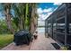 Outdoor patio with grill and lush tropical landscaping at 14448 Edna Cir, Port Charlotte, FL 33981