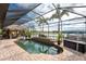 Relaxing screened pool with a tiki hut and water views at 14448 Edna Cir, Port Charlotte, FL 33981