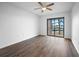 Bedroom with laminate flooring and sliding glass doors to balcony at 150 Englewood Isles Pkwy # 507, Englewood, FL 34223