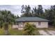 Single-story home with a green roof and landscaping at 15120 Payne St, Punta Gorda, FL 33955