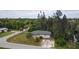 Single-story house with a green roof, driveway, and lush landscaping at 15120 Payne St, Punta Gorda, FL 33955