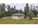Aerial view of a single story house with green roof and surrounding trees at 15120 Payne St, Punta Gorda, FL 33955