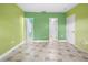Spacious bedroom with green walls and tile floors at 15120 Payne St, Punta Gorda, FL 33955