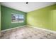 Bright bedroom with green walls, tile floors, and a window at 15120 Payne St, Punta Gorda, FL 33955