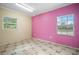 Bedroom with pink and beige walls and tile floors at 15120 Payne St, Punta Gorda, FL 33955