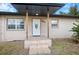 House exterior with covered entryway and landscaping at 15120 Payne St, Punta Gorda, FL 33955