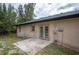 Rear view of a single-story house with a patio and french doors at 15120 Payne St, Punta Gorda, FL 33955