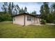House front, tan stucco exterior, green roof, small porch at 15120 Payne St, Punta Gorda, FL 33955