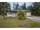 Front view of a single story house with green roof and landscaping at 15120 Payne St, Punta Gorda, FL 33955