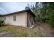 Side view of the house, showing a tan exterior and a ladder at 15120 Payne St, Punta Gorda, FL 33955