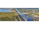 Aerial image displays a waterfront home with private dock access to a canal and surrounding residences at 15361 Visalia Rd, Port Charlotte, FL 33981
