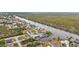 Aerial view of waterfront home and surrounding neighborhood at 15361 Visalia Rd, Port Charlotte, FL 33981