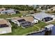 Waterfront home featuring a private dock, screened-in pool, solar panels and lush landscaping at 15361 Visalia Rd, Port Charlotte, FL 33981
