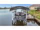 Rear view of Sylvan pontoon boat on covered lift at 15361 Visalia Rd, Port Charlotte, FL 33981
