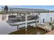 Sylvan pontoon boat on covered lift at waterfront property at 15361 Visalia Rd, Port Charlotte, FL 33981