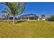 Backyard view of home with screened enclosure at 162 Annapolis Ln, Rotonda West, FL 33947