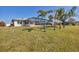 Home's backyard features a screened enclosure and grassy lawn at 162 Annapolis Ln, Rotonda West, FL 33947