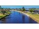 Aerial view of waterfront homes and lush landscaping along a canal at 162 Annapolis Ln, Rotonda West, FL 33947