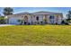 Front view of a charming house with a well-maintained lawn at 162 Annapolis Ln, Rotonda West, FL 33947