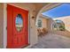 Close-up of a bright orange front door with glass accents at 162 Annapolis Ln, Rotonda West, FL 33947