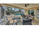 Relaxing pool area with patio furniture and canal view at 162 Annapolis Ln, Rotonda West, FL 33947