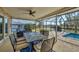 Outdoor patio with table and chairs overlooking the pool at 162 Annapolis Ln, Rotonda West, FL 33947