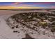 Aerial view of waterfront home with sunset at 16271 N Island Ct, Boca Grande, FL 33921