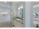 Bathroom with double vanity and light blue walls at 16271 N Island Ct, Boca Grande, FL 33921